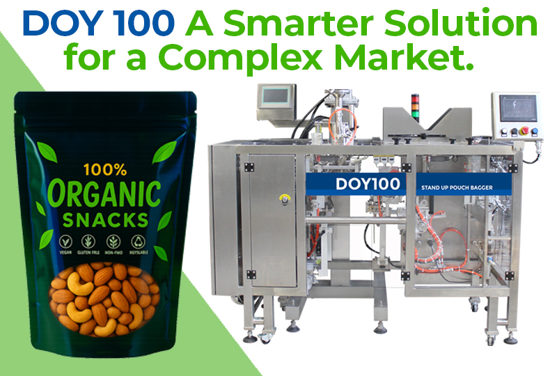 A modern snack packaging machine, the DOY 100, shown alongside a resealable stand-up pouch filled with organic snacks like almonds.