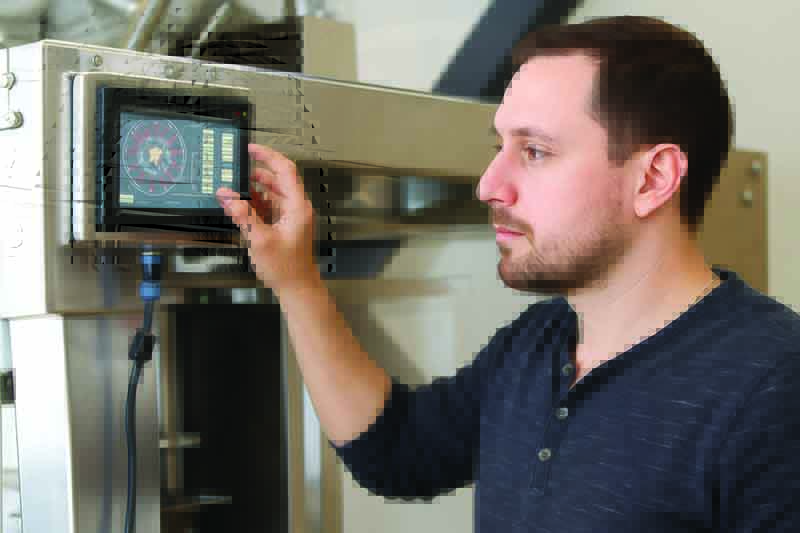 Man Looking at Machine Screen