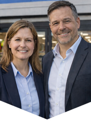 Retail business owners standing outside a store, representing packaging insights for retailers