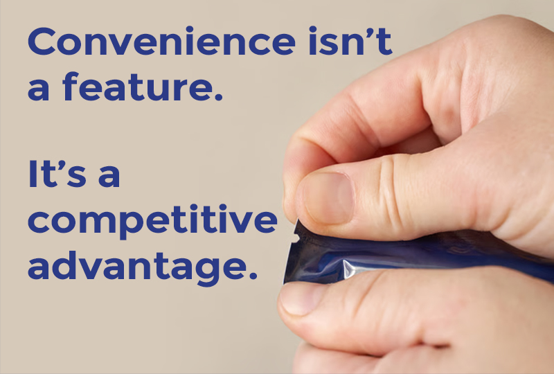 Hand opening a flexible packaging pouch highlighting convenience and ease of use