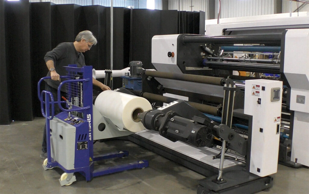 Man Loading Slitting Machine